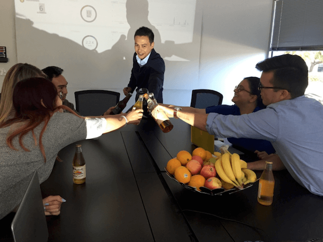 toasting beers during meeting in conference room